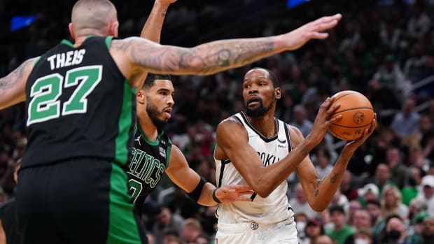 Brooklyn Nets forward Kevin Durant (7) looks to pass against Boston Celtics forward Jayson Tatum.